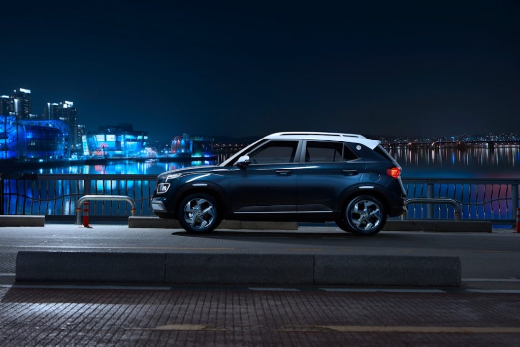 The Hyundai VENUE standing in front of the nighttime cityscape