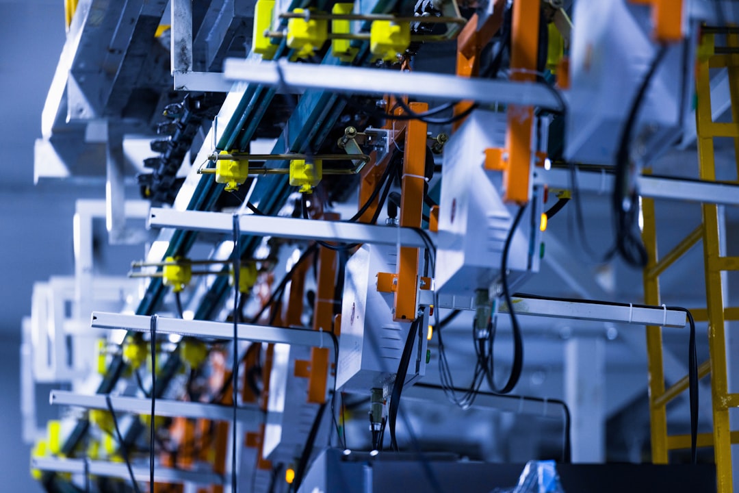 Close-up view of a fully automated line for the dynamic testing of cooling performance in a refrigerator manufacturing plant.